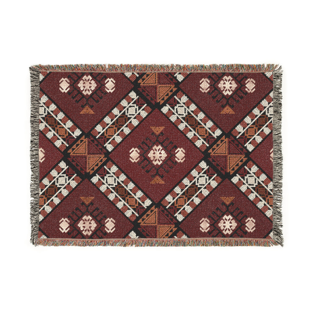 Woven blanket with geometric pattern on a white background

